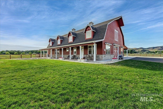 3800 Birch Ln, Emmett, ID 83617 - view of front of home featuring a porch, stone siding, a chimney, a gambrel roof, and roof with shingles