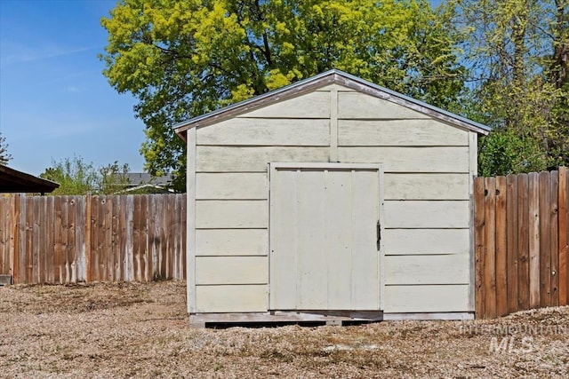 view of shed featuring fence