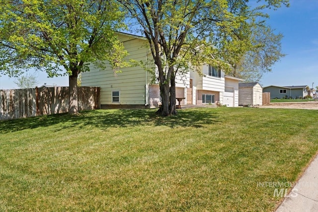 view of yard featuring fence and driveway