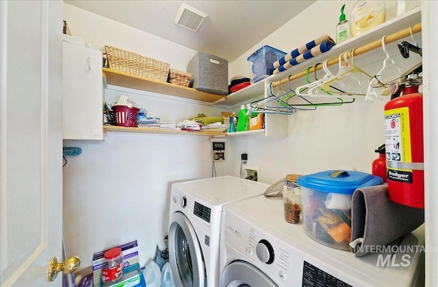 laundry area featuring laundry area, washer and clothes dryer, and visible vents