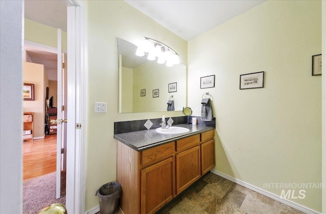 bathroom with baseboards and vanity