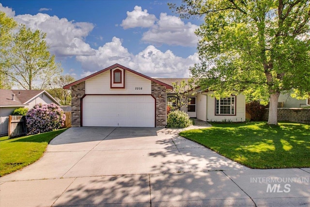 ranch-style home with fence, a front lawn, brick siding, a garage, and driveway