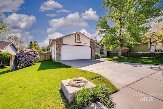 view of front facade with concrete driveway, brick siding, fence, and a front lawn