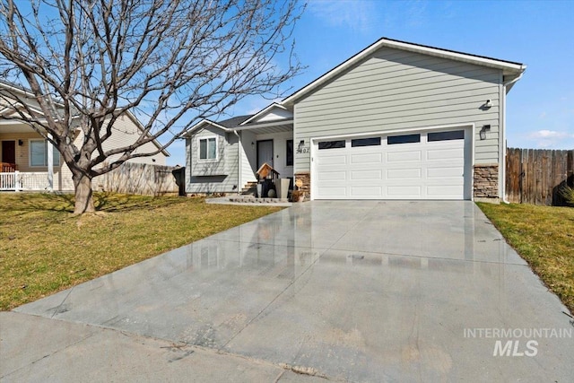 ranch-style house with an attached garage, fence, a front yard, stone siding, and driveway