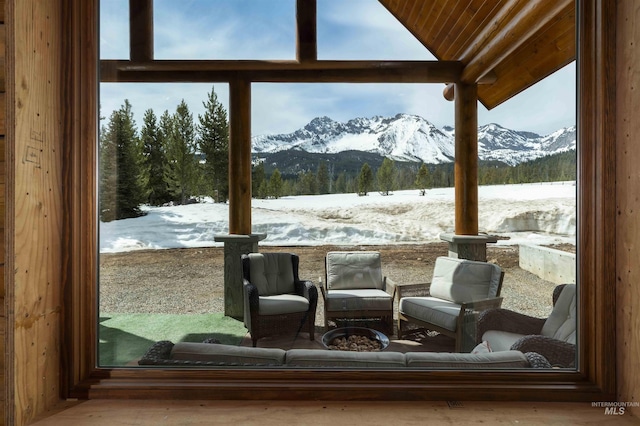 snow covered patio with a mountain view