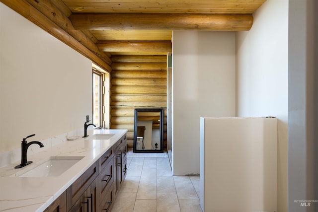 interior space featuring wooden ceiling, log walls, a sink, and light tile patterned floors