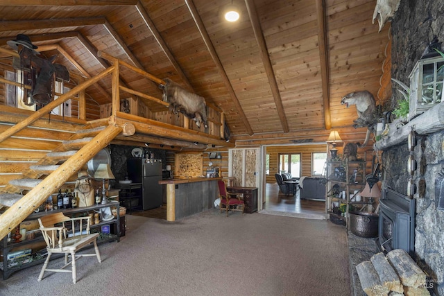 carpeted living area featuring high vaulted ceiling, wooden ceiling, a wood stove, and beamed ceiling