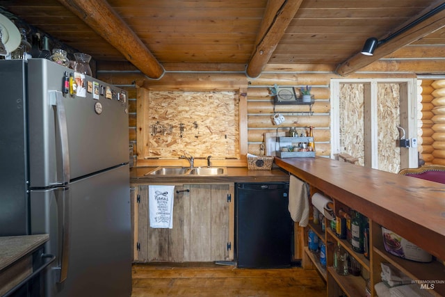 kitchen featuring a sink, freestanding refrigerator, wood ceiling, fridge, and log walls