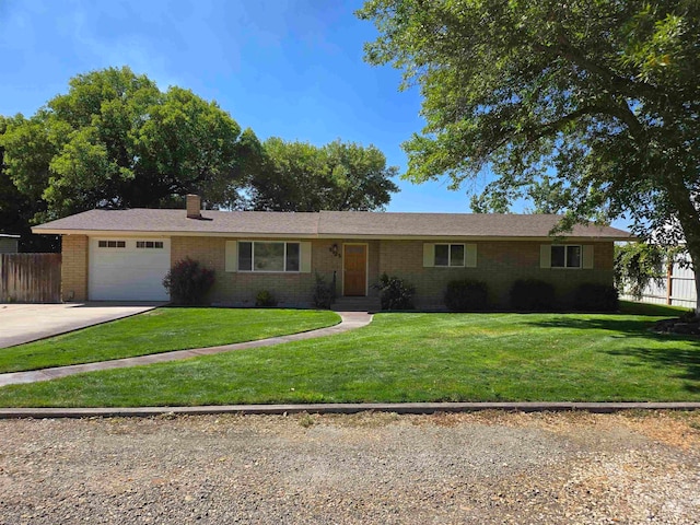 single story home featuring a garage and a front yard