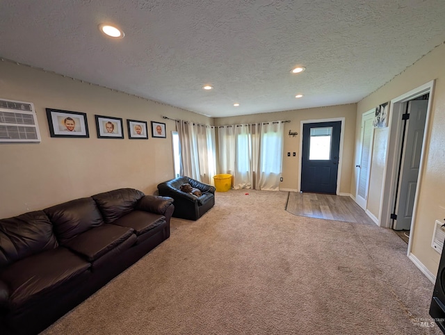 116 Main St, Stites, ID 83552 - carpeted living room with recessed lighting, a wall mounted air conditioner, a textured ceiling, and baseboards