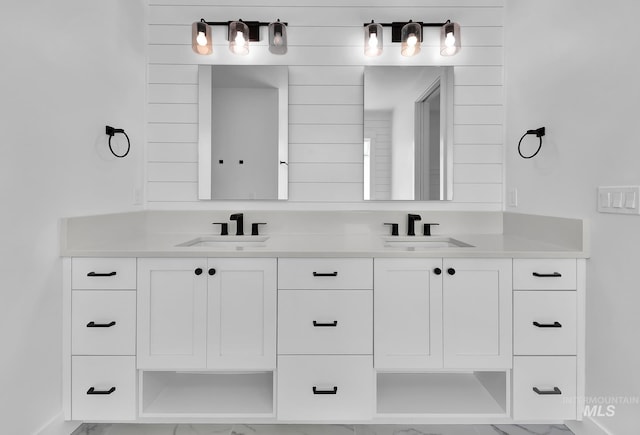 bathroom with double vanity and marble finish flooring