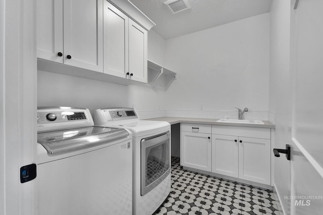 washroom featuring washer and clothes dryer and cabinet space