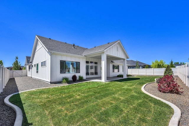 rear view of property featuring board and batten siding, a patio, and roof with shingles