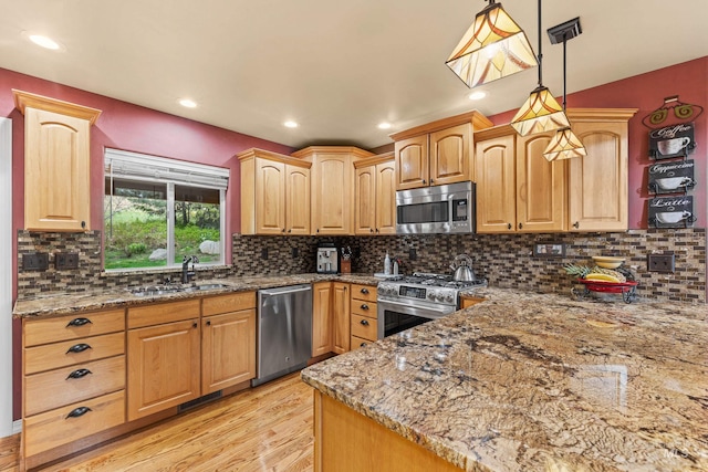 1611 Woodhaven Ln, Mccall, ID 83638 - kitchen with stainless steel appliances, a sink, light wood finished floors, stone counters, and recessed lighting
