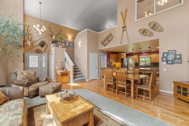 1611 Woodhaven Ln, Mccall, ID 83638 - living area with a high ceiling, a chandelier, light wood-style floors, stairs, and baseboards
