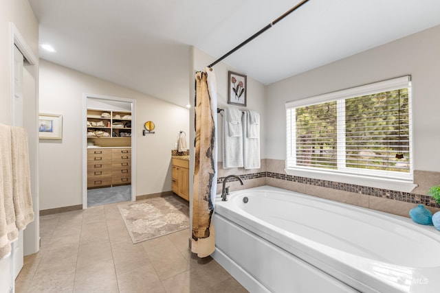 1611 Woodhaven Ln, Mccall, ID 83638 - full bath with a garden tub, vanity, a walk in closet, lofted ceiling, and tile patterned flooring