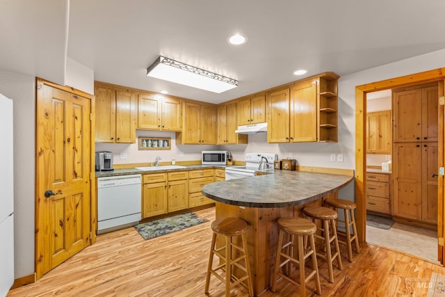 1611 Woodhaven Ln, Mccall, ID 83638 - kitchen featuring white appliances, under cabinet range hood, a sink, open shelves, and light wood-type flooring