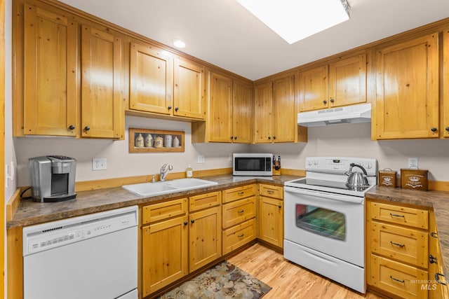 1611 Woodhaven Ln, Mccall, ID 83638 - kitchen featuring under cabinet range hood, white appliances, a sink, light wood-style flooring, and dark countertops