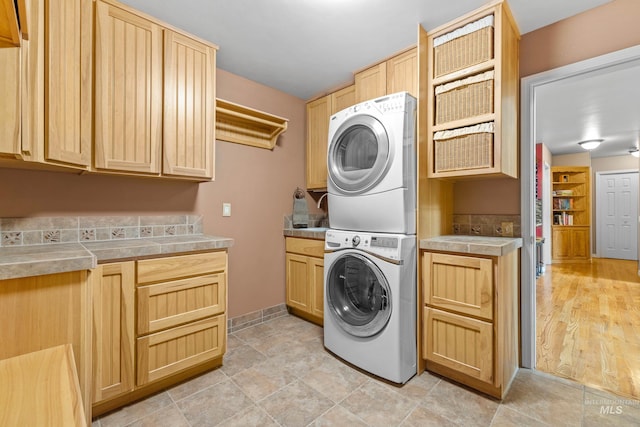 1611 Woodhaven Ln, Mccall, ID 83638 - laundry room with stacked washer and clothes dryer, cabinet space, and baseboards