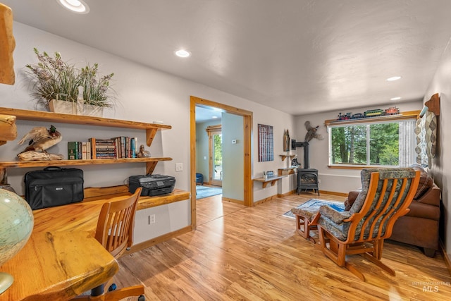 1611 Woodhaven Ln, Mccall, ID 83638 - office space featuring a wood stove, light wood finished floors, recessed lighting, and baseboards