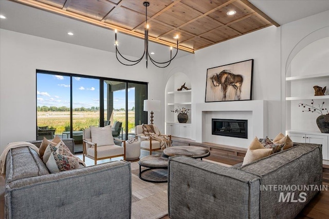 461 Centry Ave, Middleton, ID 83644 - living area with built in shelves, wood ceiling, recessed lighting, a glass covered fireplace, and wood finished floors