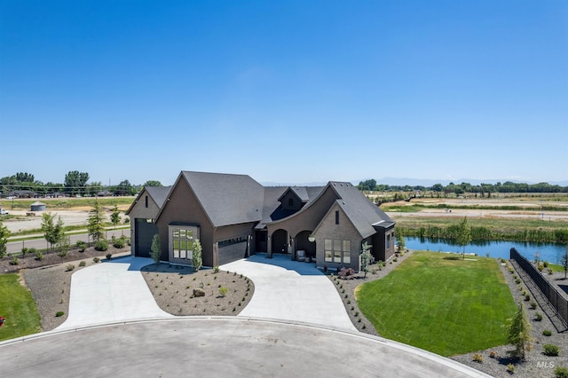 461 Centry Ave, Middleton, ID 83644 - french country home featuring a garage, a water view, concrete driveway, a front yard, and stucco siding