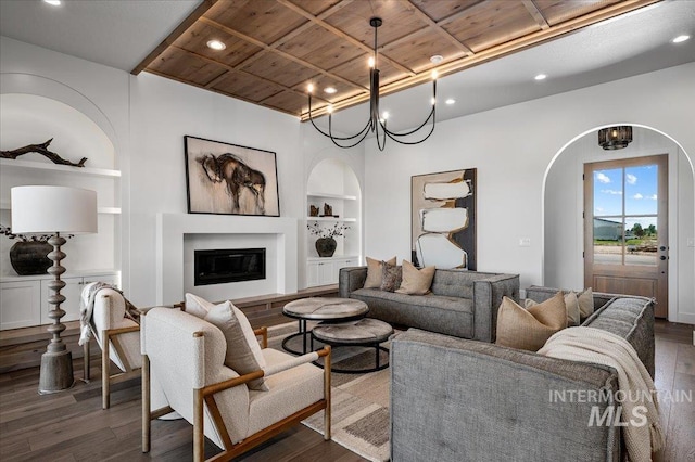 461 Centry Ave, Middleton, ID 83644 - living room featuring built in features, arched walkways, dark wood-style floors, a glass covered fireplace, and recessed lighting