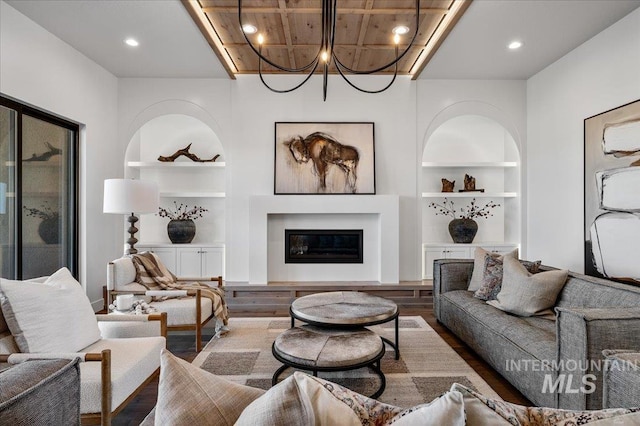 461 Centry Ave, Middleton, ID 83644 - living room featuring built in shelves, wood finished floors, a glass covered fireplace, recessed lighting, and a chandelier