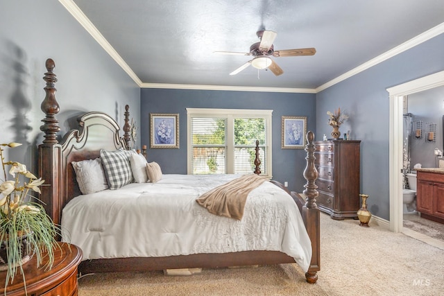 bedroom featuring carpet, ensuite bathroom, ornamental molding, a ceiling fan, and baseboards