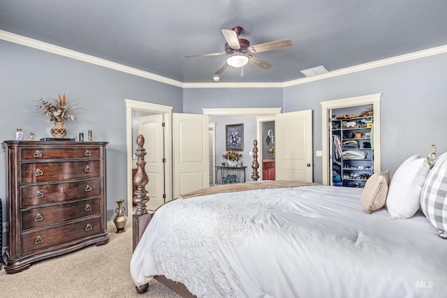 carpeted bedroom with crown molding, a spacious closet, a ceiling fan, and a closet