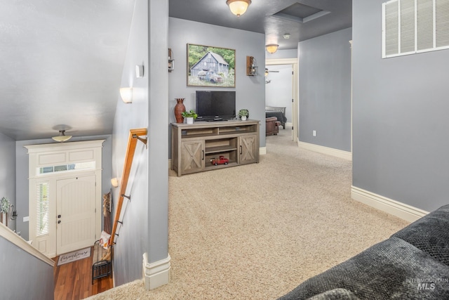 interior space with carpet, attic access, visible vents, and baseboards