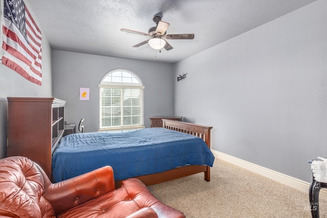 bedroom featuring carpet flooring, ceiling fan, a textured ceiling, and baseboards