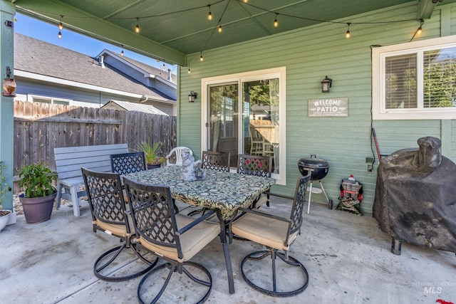 view of patio featuring outdoor dining space and fence