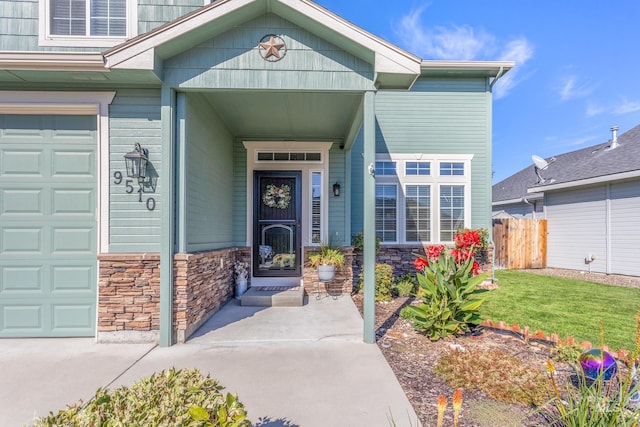 view of exterior entry with stone siding and fence