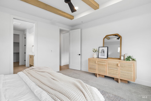 carpeted bedroom featuring beamed ceiling and baseboards