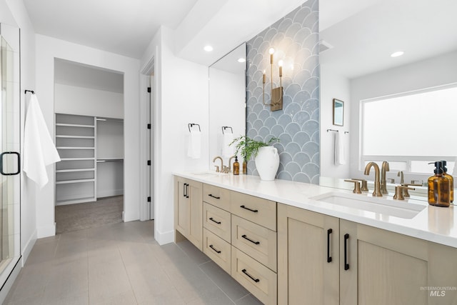 full bathroom with a sink, a shower stall, recessed lighting, and double vanity