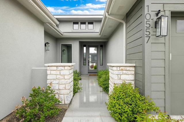 view of exterior entry with stucco siding