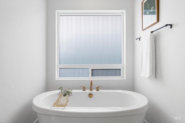 bathroom with a freestanding tub and plenty of natural light