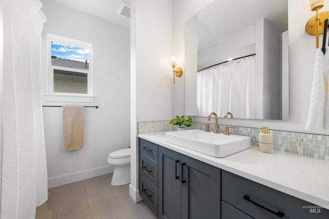full bathroom featuring vanity, decorative backsplash, toilet, baseboards, and tile patterned floors