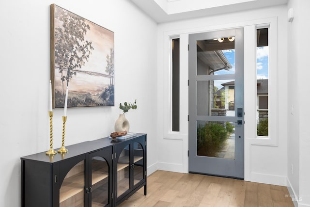 entryway with baseboards and wood finished floors