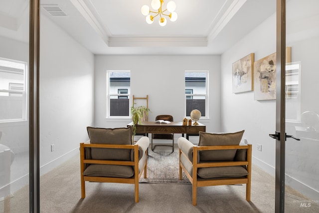 carpeted home office featuring plenty of natural light, ornamental molding, a notable chandelier, and a tray ceiling