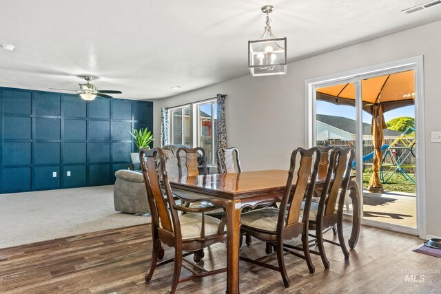 dining area with a ceiling fan and wood finished floors