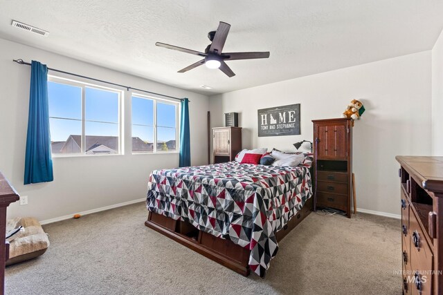 bedroom featuring carpet flooring, baseboards, a ceiling fan, and a textured ceiling