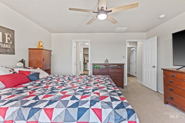 bedroom featuring light carpet and ceiling fan