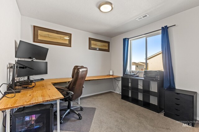 carpeted office featuring baseboards