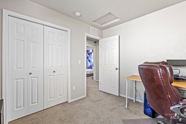 office space with attic access, carpet, and baseboards