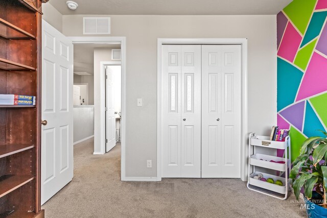 bedroom featuring carpet flooring, a closet, and baseboards