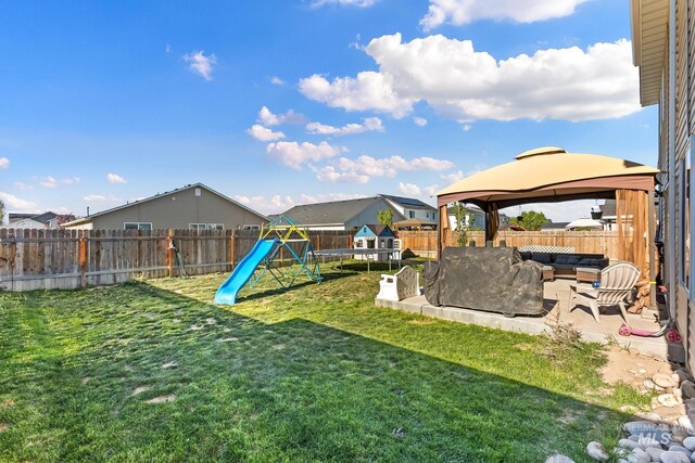 view of yard with a gazebo, outdoor lounge area, a playground, and a patio area