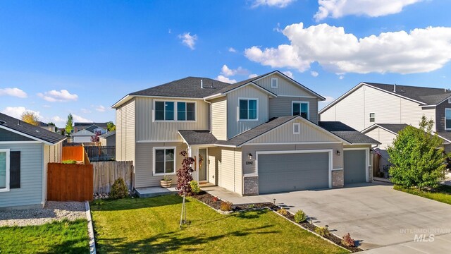 view of front of house featuring board and batten siding, a garage, concrete driveway, and roof with shingles