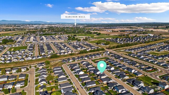aerial view of property's location with mountains and nearby suburban area